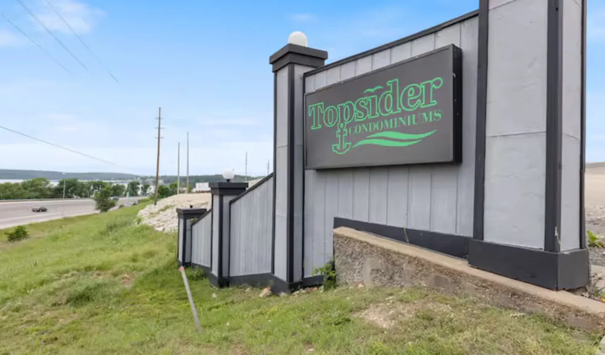 An inviting shot of the Topsider Condominiums sign at the entrance, surrounded by landscaped steps and greenery. This welcoming approach hints at the vibrant community within and hints at easy access to local attractions.