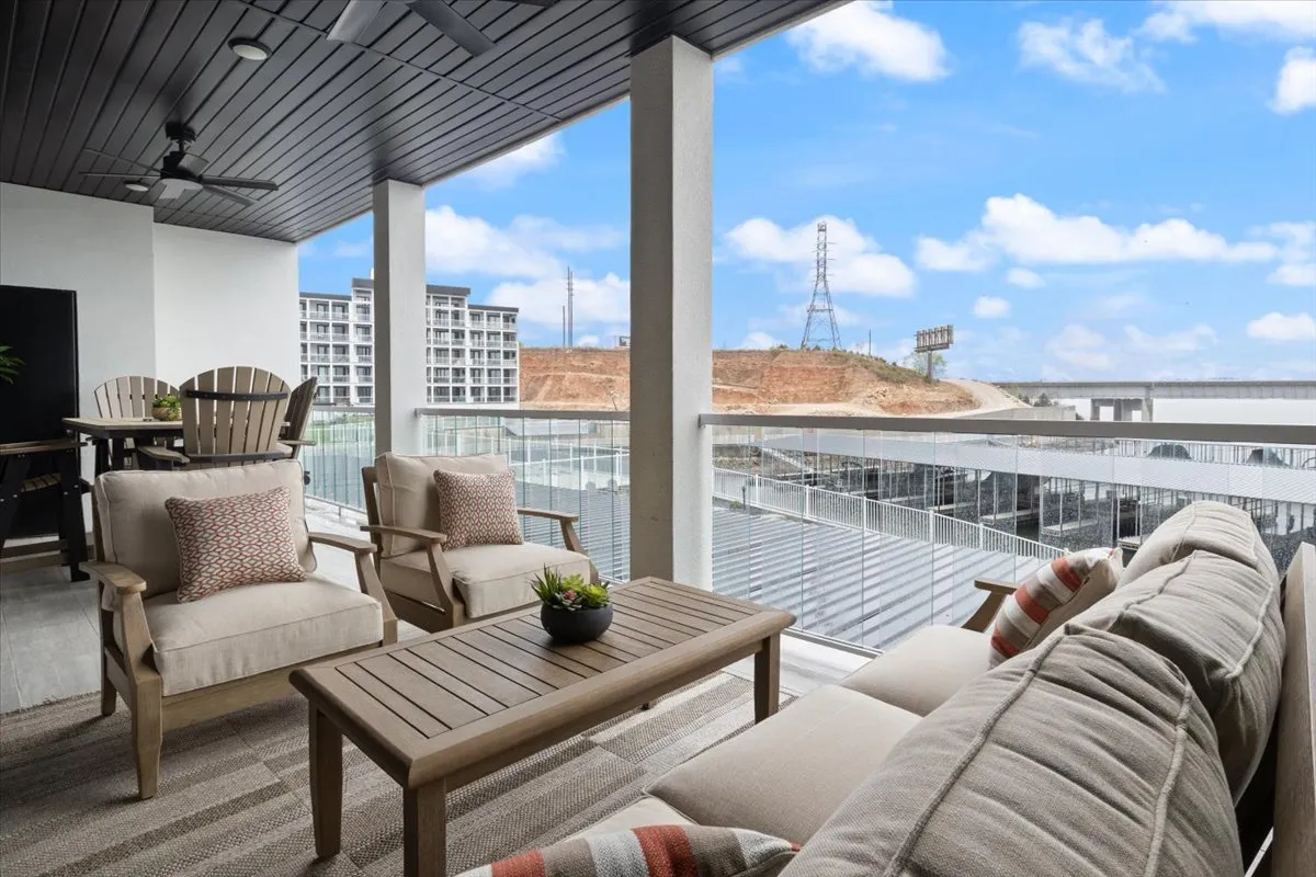 This image highlights an outdoor seating area with a potted plant and a wide view of the landscape. The scene suggests a tranquil spot for relaxing with a pet, enjoying sunrise or starlit evenings in a natural setting.